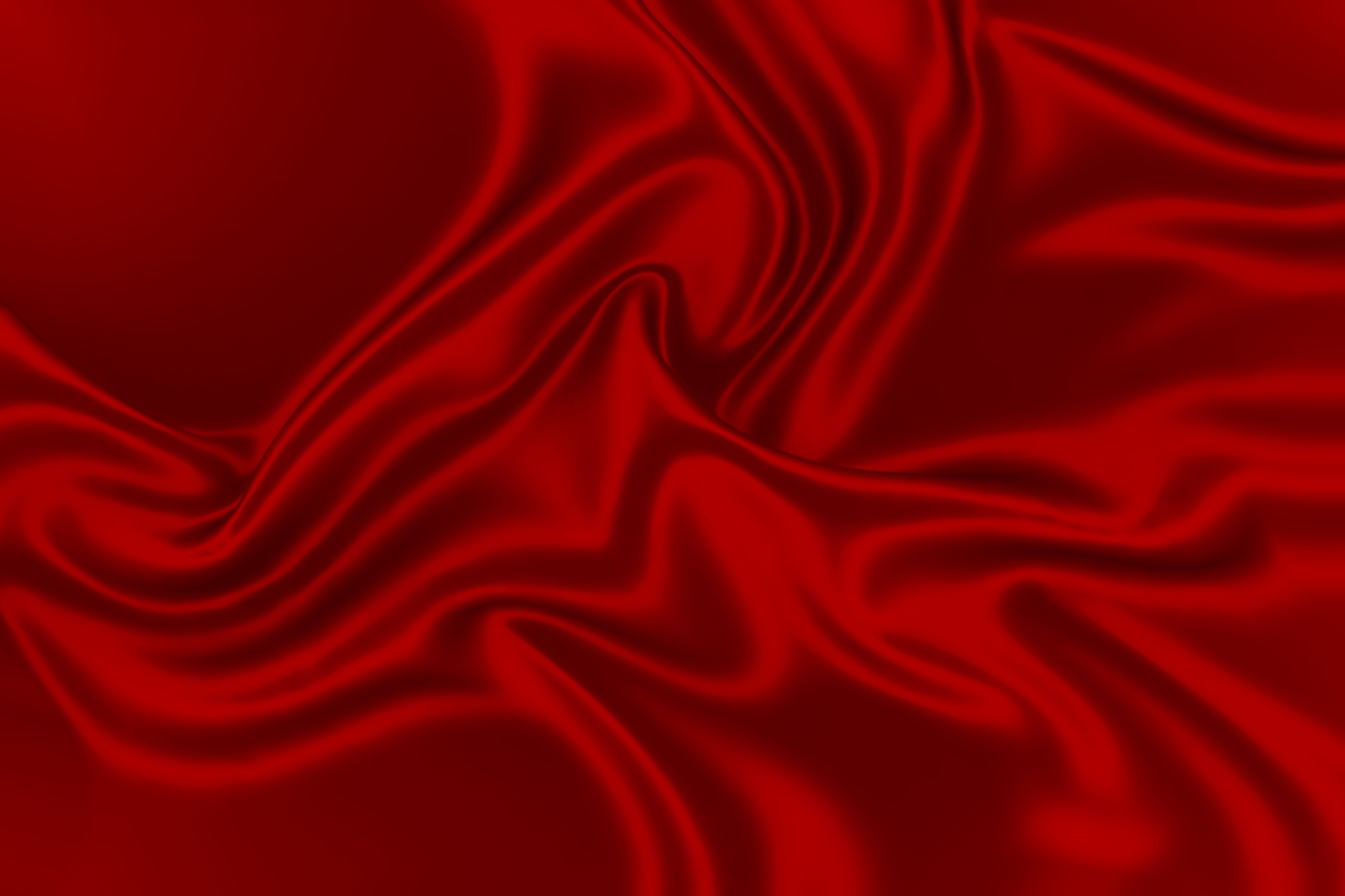 Red silk fabric texture cloth backdrop. Color closeup background